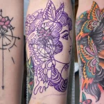 Cover up tattoo artist in Delray Beach reviewing a design overlay at Vatican Tattoo Studio